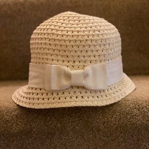 Cream Cloche hat with bow.
